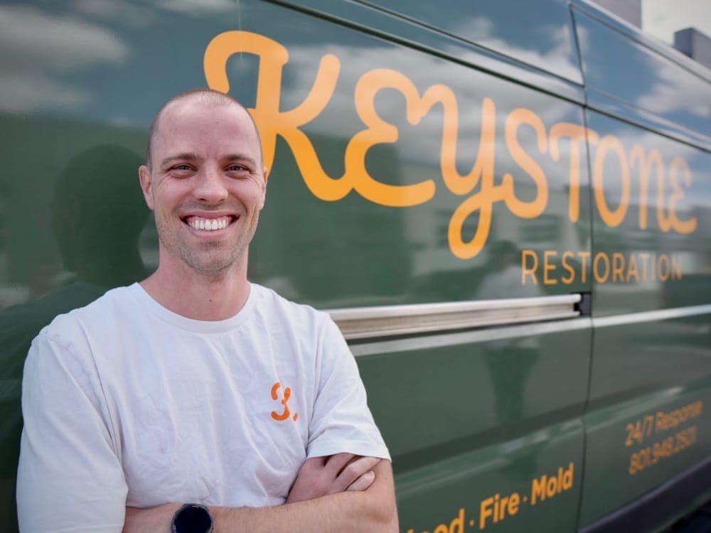 Tim Thomas, estimator at Keystone Restoration, in front of the company van in Bluffdale, Utah